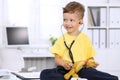 Little doctor examining a ntoy bear patient by stethoscope Royalty Free Stock Photo