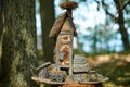 Little dollhouse in woods, cute small decorative house outdoor art exhibition in public park