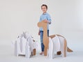 Little dreamer boy playing with a cardboard dinosaurs Brontosaurus and Ankylosaurus. Childhood. Fantasy, imagination.