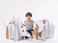 Little dreamer boy playing with a cardboard dinosaurs Triceratops and Stegosaurus. Childhood. Fantasy, imagination. Royalty Free Stock Photo