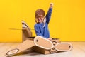 Little dreamer girl playing with a cardboard airplane. Childhood. Fantasy, imagination. Royalty Free Stock Photo