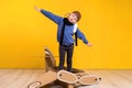 Little dreamer girl playing with a cardboard airplane. Childhood. Fantasy, imagination. Royalty Free Stock Photo