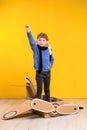 Little dreamer girl playing with a cardboard airplane. Childhood. Fantasy, imagination.