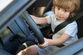 Little Driver. Cute little boy pretending to drive. Kid in car with his hands on the wheel. Child Driver. Little kid Royalty Free Stock Photo