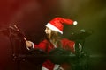 Little drummer disguised as Santa Claus playing the electronic drum kit