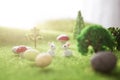 Little Easter bunny toys and Easter eggs on green grass. Fairy tale Royalty Free Stock Photo