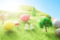 Little Easter bunny toys and Easter eggs on green grass. Fairy tale Royalty Free Stock Photo