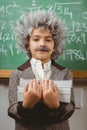 Little Einstein holding books in front of chalkboard