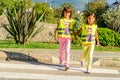 Little elementary school kids crossing the street wearing a vest with the stop sine on it