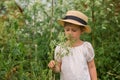 Little emotional Girl in a white boho dress with a hat smiling playing Royalty Free Stock Photo
