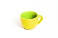 Little empty ceramic yellow and green coffee mug , coffee cup isolated on white background Royalty Free Stock Photo