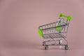 Little empty shopping cart on pink background Royalty Free Stock Photo