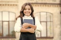 Little expert in books. Happy girl hold library book outdoor. School bibliopole. Bibliopole and bibliomania. Bibliopole Royalty Free Stock Photo