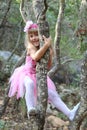 Little fairy ballerina playing in a forest