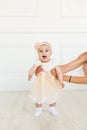 Little fairy. sweet ballerina with fluffy peach skirt and flower. Cute smiling baby girl on white studio backgroung. 6 Royalty Free Stock Photo