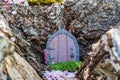 Little fairy tale door made from clay in cherry tree trunk Royalty Free Stock Photo