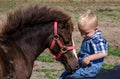 Little farm boy with pony