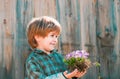 Little Farmer boy examining Common fig crop in plantation or field. Cute kid boy watering the sprout on field. Flower Royalty Free Stock Photo