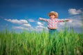 Little farmer boy with straw hat in a green wheat field. Agriculture and farming concept Royalty Free Stock Photo