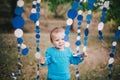 Little fashion boy in a forest wearing blue sweater and jeanse Royalty Free Stock Photo