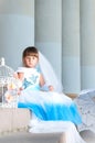 Little fashion-girl in magnificent blue and white evening dress