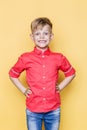 Little fashionable child with pink shirt. Fashion model. Spring. Summer. Studio portrait over yellow background Royalty Free Stock Photo