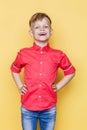 Little fashionable child with pink shirt. Fashion model. Spring. Summer. Studio portrait over yellow background Royalty Free Stock Photo