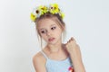 Little fashionista. Closeup beautiful little girl kid, wreath of yellow flowers floral head band on head light blue dress shirt Royalty Free Stock Photo