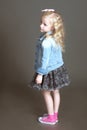 Little fashionista posing in denim suit