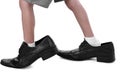 Little feet in a big shoes Royalty Free Stock Photo