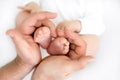 Little feet in daddy`s hands. dad holds the baby`s legs. Royalty Free Stock Photo