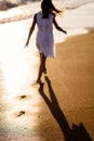 Little feet leave footprints on sandy shore of sea. walks on beach