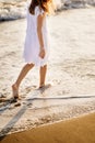 Little feet leave footprints on sandy shore of sea. walks on beach