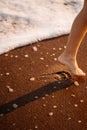 Little feet leave footprints on sandy shore of sea. walks on beach