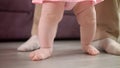 Little feet walking on floor. Child steps with father support Royalty Free Stock Photo