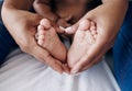 These little feet will always have my heart. an unrecognisable woman sitting on the bed at home and holding her babys Royalty Free Stock Photo