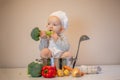 Little female chef preparing vegetable soup in kitchen Royalty Free Stock Photo