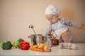 Little female chef preparing vegetable soup in kitchen Royalty Free Stock Photo