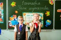Little first-grader, girl-student goes to school on knowledge day - September First. Student of elementary school in uniform with