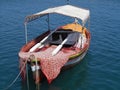 Little fishing boat floating on bright blue sea