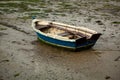 Little fishing boat stranded on the wet sand