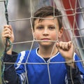 Little football player near the gates of the stadium. Sport.