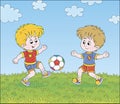 Little football players kicking a ball Royalty Free Stock Photo