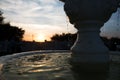 Little fountain on the background of a beautiful sunset