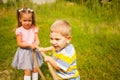 Little friends playing tug of war in a park Royalty Free Stock Photo