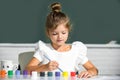 Little funny artist painting, drawing art. Cute little girl child painting with paints color and brush. Drawing lesson Royalty Free Stock Photo