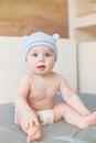 Little funny baby boy with big blue eyes smiling with cute cap with ears on his head Royalty Free Stock Photo