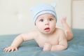 Little funny baby boy with big blue eyes smiling with cute cap with ears on his head Royalty Free Stock Photo