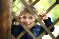 Little funny boy behind the fence Royalty Free Stock Photo