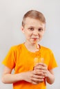 Little funny boy drinking fresh cola through a straw Royalty Free Stock Photo